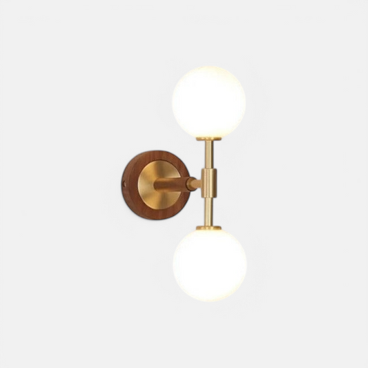 LUXELY brass wall sconce with modern copper finish and dual frosted glass globes, ideal for bedroom or hallway lighting.