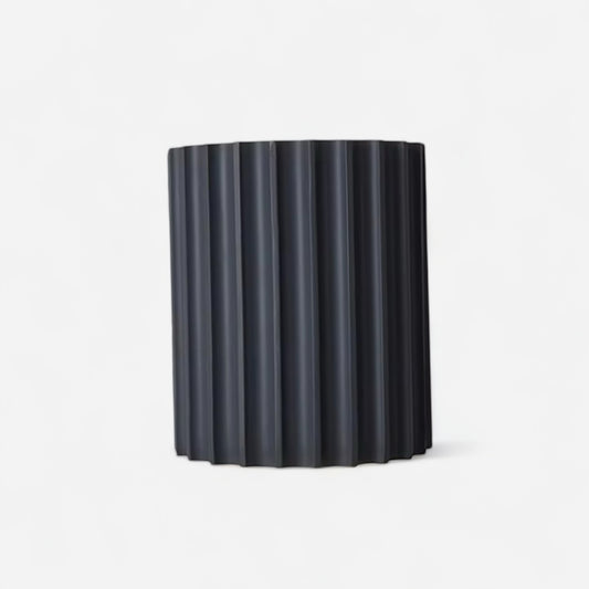 Black resin modern wall lamp with vertical grooves, ideal for minimalist bedroom or hallway lighting in contemporary interiors.
