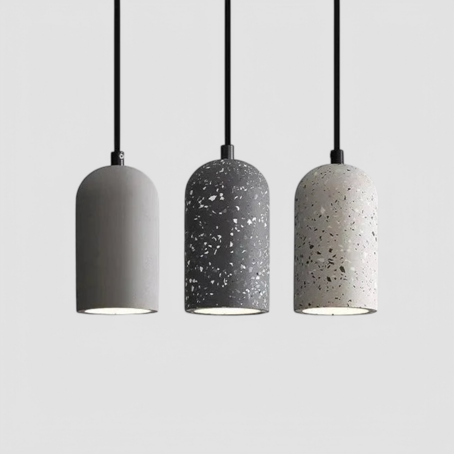 Set of three LUXELY modern minimalist cement pendant lamps in gray and terrazzo finishes. Ideal for industrial and contemporary interiors.