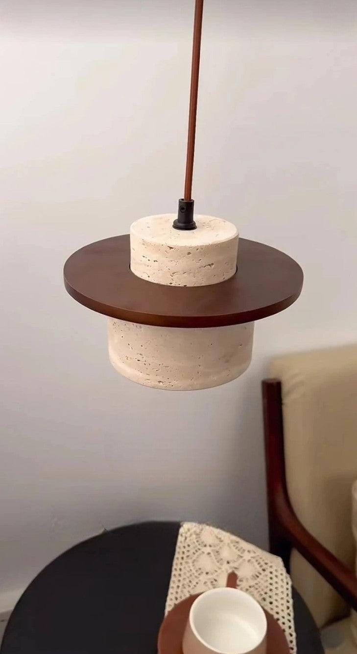LUXELY travertine pendant lamp with dark wood disc, hanging above a table, perfect for cozy and modern interior lighting.