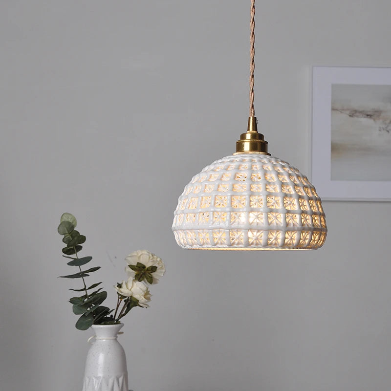 LUXELY ceramic LED pendant light illuminated, showcasing intricate cut-out pattern and warm ambient glow for cozy spaces.