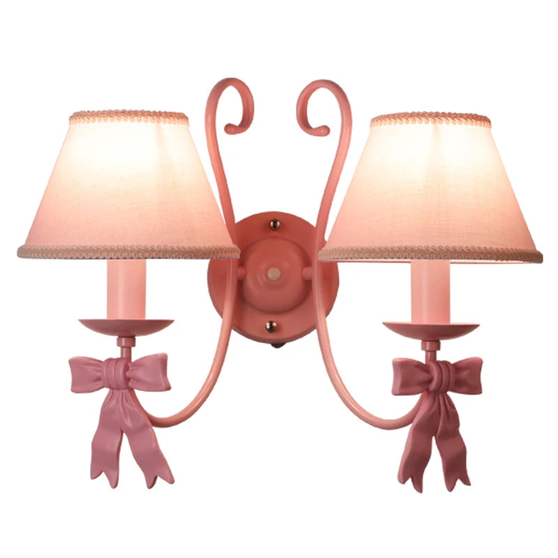 Front view of dual-lamp Bowknot Princess Room Chandelier with pink iron base and bow accents, ideal for wall-mounted indoor lighting.