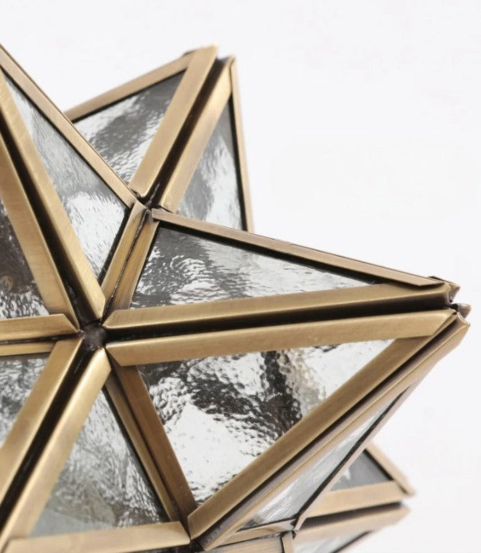 Close-up of star-shaped glass and copper frame, emphasizing the detailed craftsmanship of the ceiling light fixture.