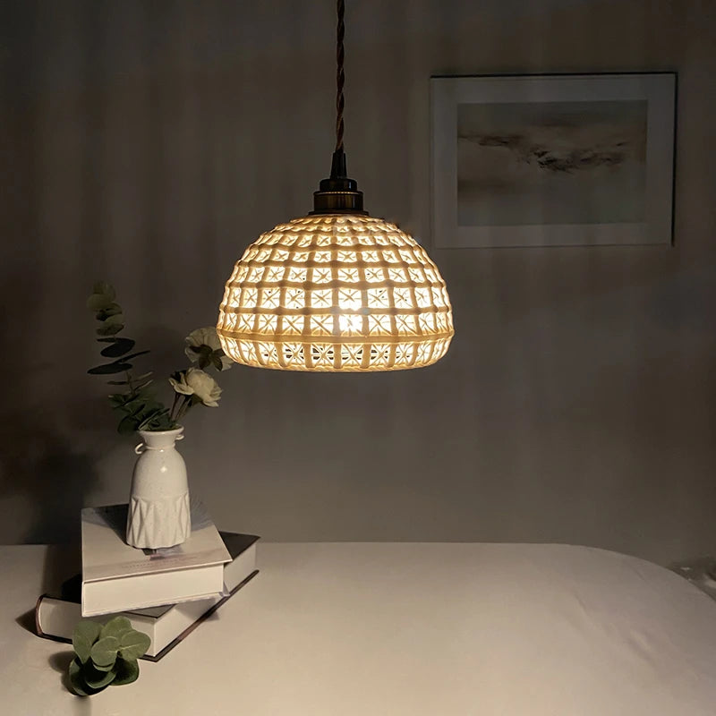 Vintage ceramic pendant lamp glowing warmly in a dim room, ideal for bedroom or restaurant ambiance lighting.