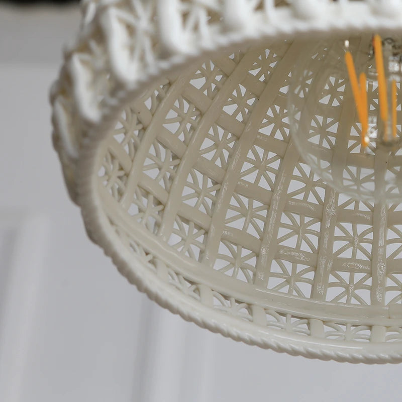 Interior view of LUXELY ceramic LED pendant light showing bulb and intricate inner lattice pattern for decorative lighting.