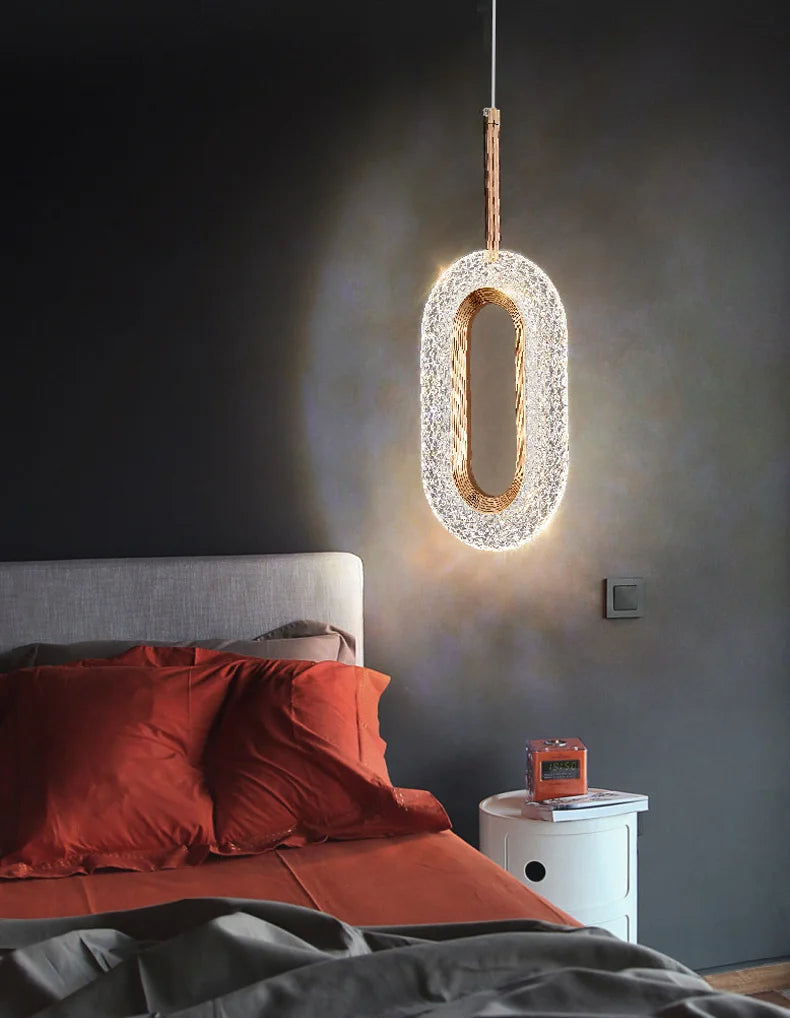 Modern Nordic pendant light above bedside table, adding a warm glow and stylish touch to a contemporary bedroom.