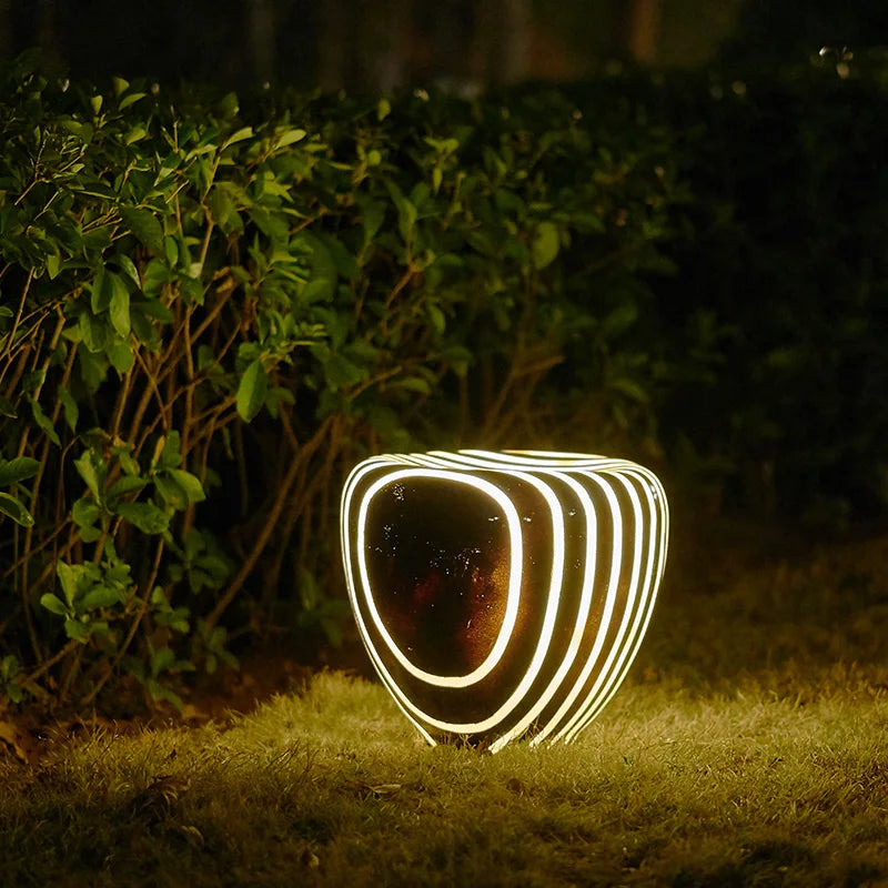 Outdoor light waterproof stone garden light glowing beside a hedge, offering decorative and functional lighting for night landscapes.