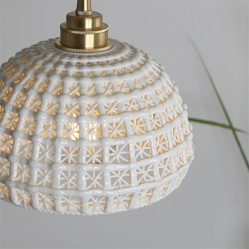 Close-up of LUXELY ceramic pendant light with brass top and detailed lattice texture, blending retro and modern styles.