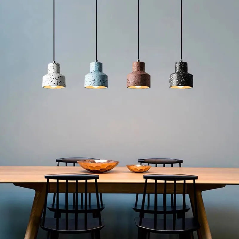 Terrazzo stone pendant lights by LUXELY hanging above a dining table, ideal for modern dining room or restaurant lighting decor.