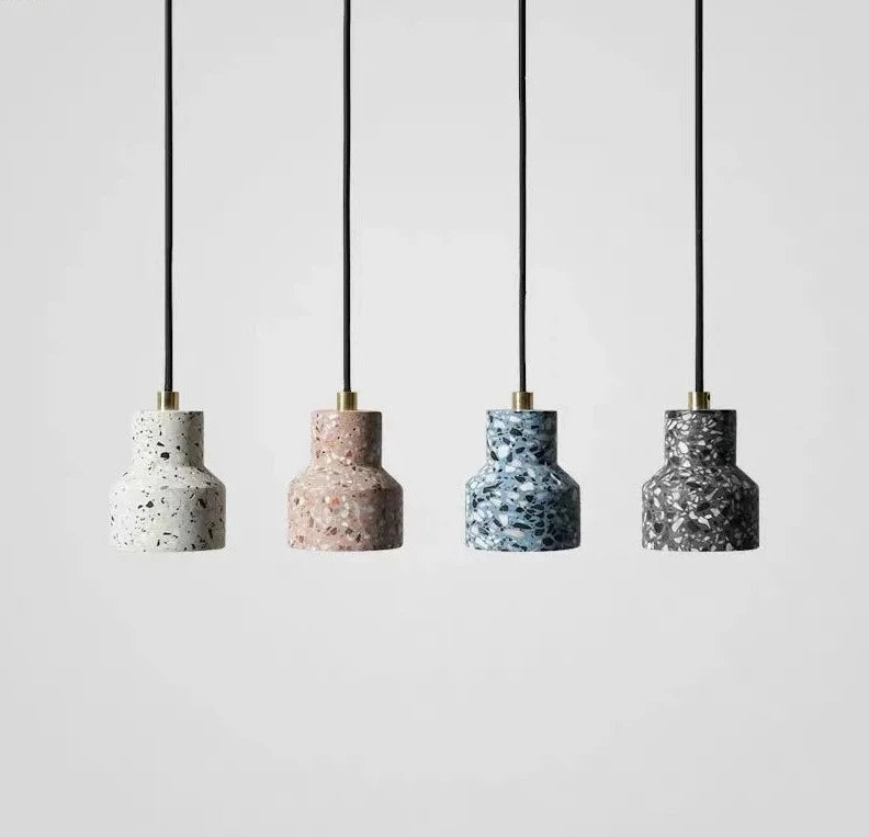 Set of four LUXELY terrazzo LED pendant lights in white, pink, blue, and black cement finishes, perfect for modern ceiling fixtures.