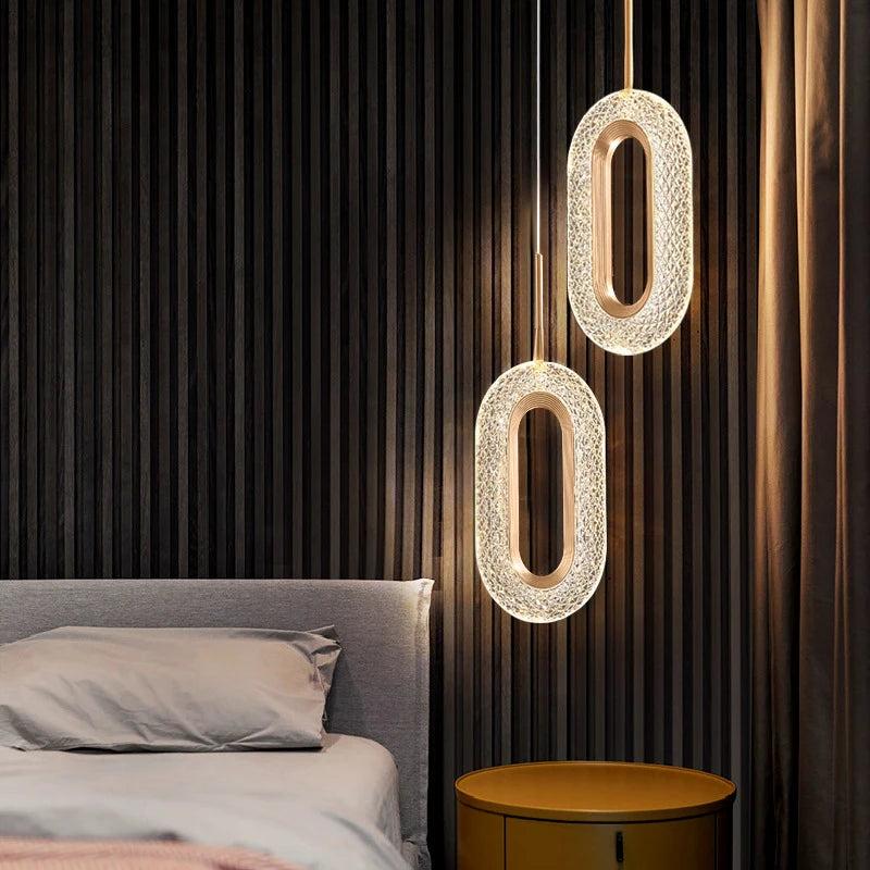 Bedroom setup featuring modern Nordic oval pendant lights with warm glow, perfect for bedside ambiance and modern interiors.
