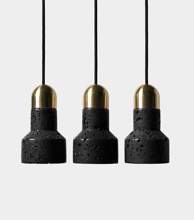 Set of three LUXELY black terrazzo pendant lights with brass tops. Industrial pendant lighting ideal for kitchen islands or bars.