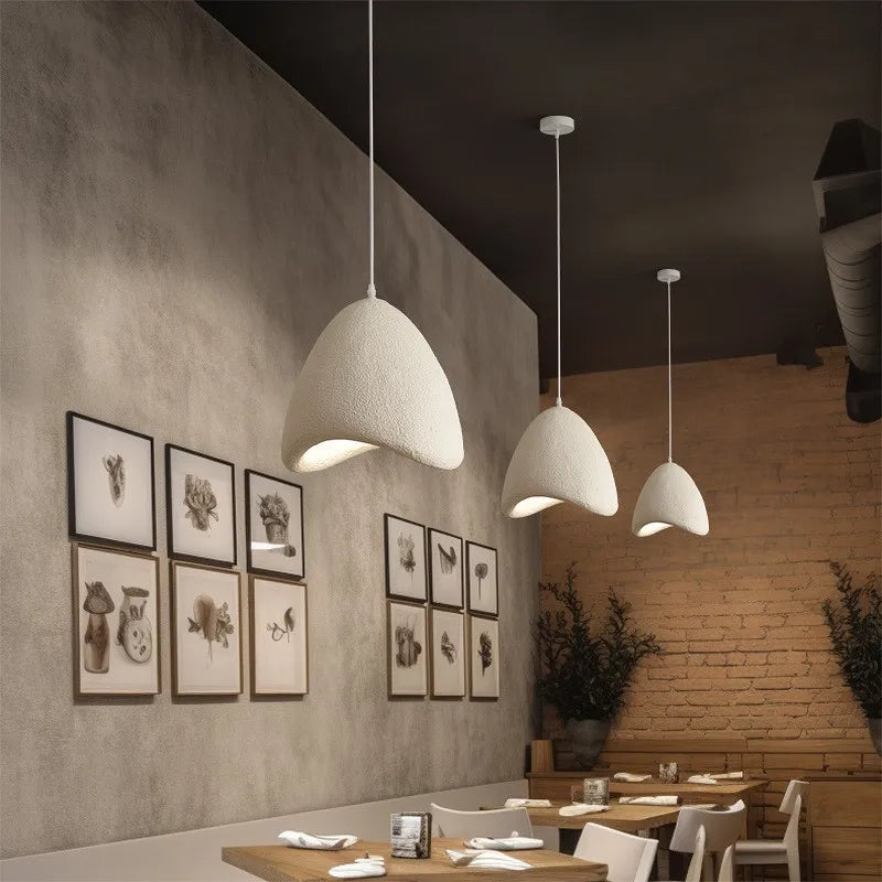 Minimalist dome-shaped pendant lights in a restaurant setting, part of the Nordic wabi-sabi LED collection with art deco influence.