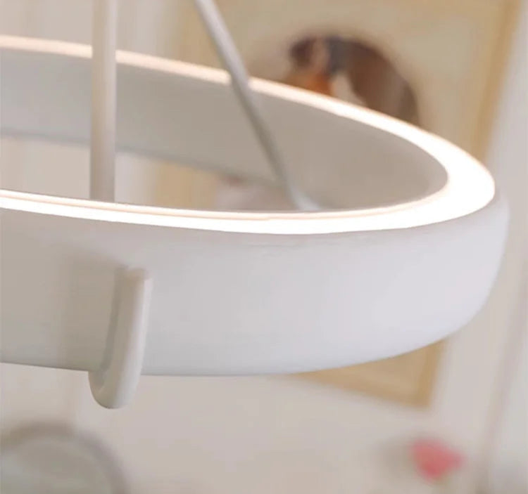 Smooth LED ring of carved plaster chandelier - french farmhouse ceiling light with minimalist design and soft lighting.