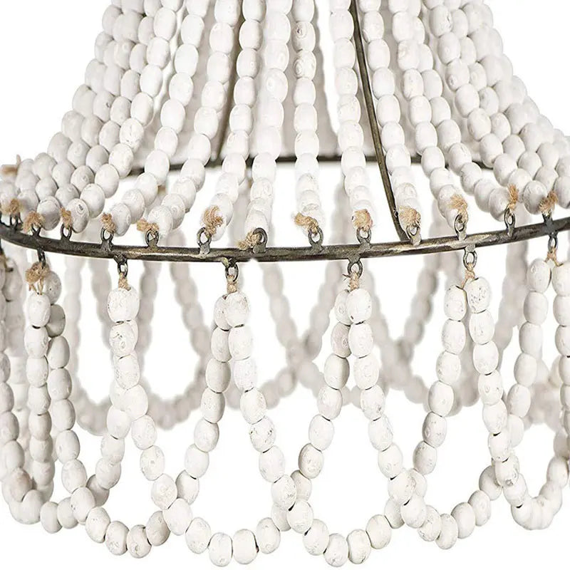 Detail of white wooden beads and curved design on the Bohemian Bead Chandelier, emphasizing handcrafted rustic elegance.
