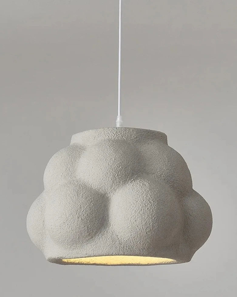 Green cloud-shaped pendant light with textured surface and LED bulb, perfect for playful and modern home decor.