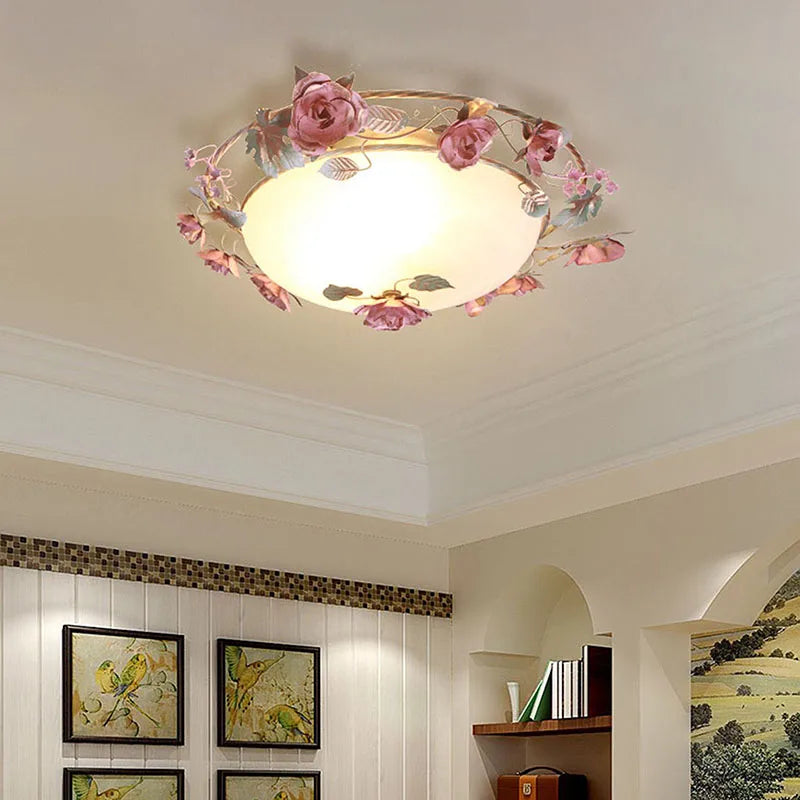 Romantic pink chandelier with floral accents in a modern living space. French rose design adds charm to home lighting décor.