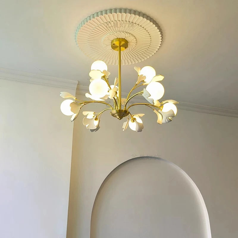 Elegant hanging ceiling lamp with LED bulbs, featuring a gold stem and white flower-shaped diffusers, ideal for dining room lighting.