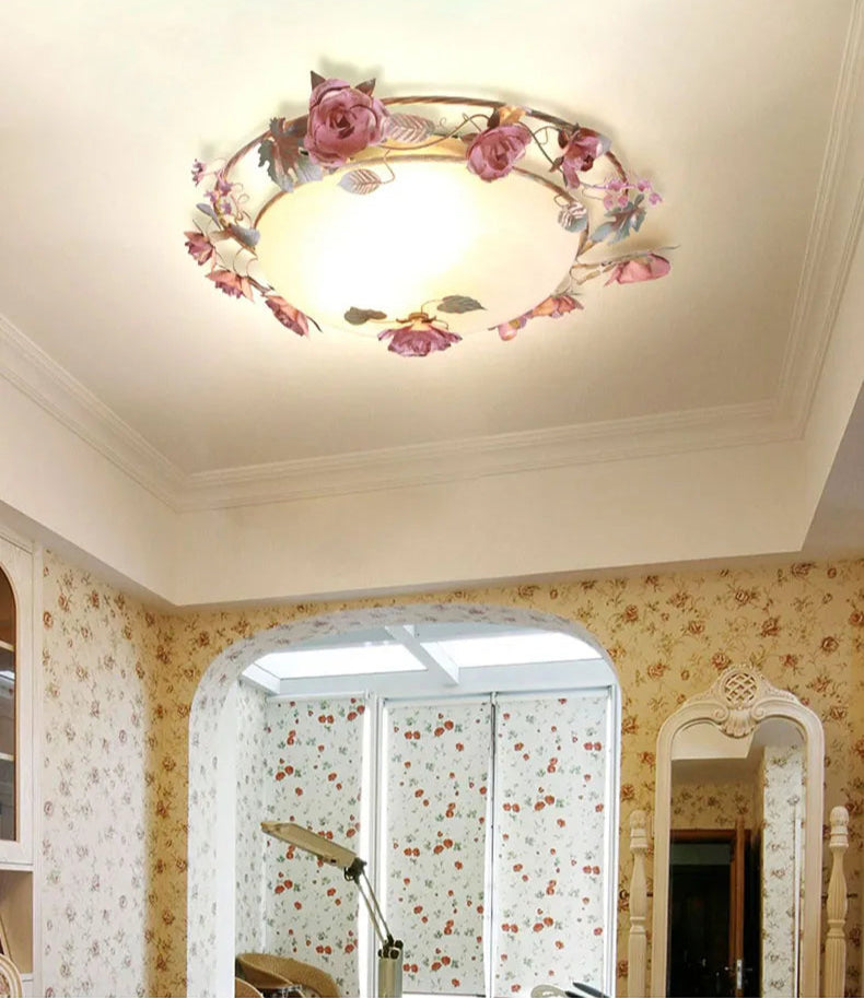 Romantic pink chandelier with floral frame in a floral-themed room. French rose ceiling light adds elegance to home décor.