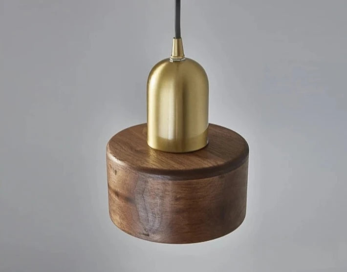 Top-down view of LUXELY pendant lamp showing solid walnut wood base and brass dome, ideal for retro or wabi-sabi decor.