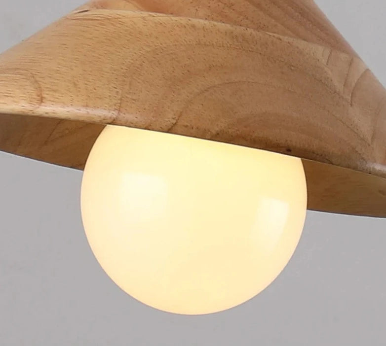 Close-up of glowing bulb under Nordic wood pendant light, ideal for warm and inviting kitchen or dining room ambiance.