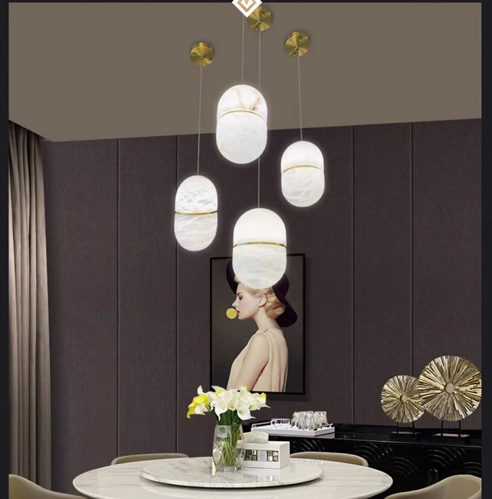 Five oval marble LED pendant lights above a dining table. Marble LED pendant light – modern ceiling lamp dimmable for dining room decor.