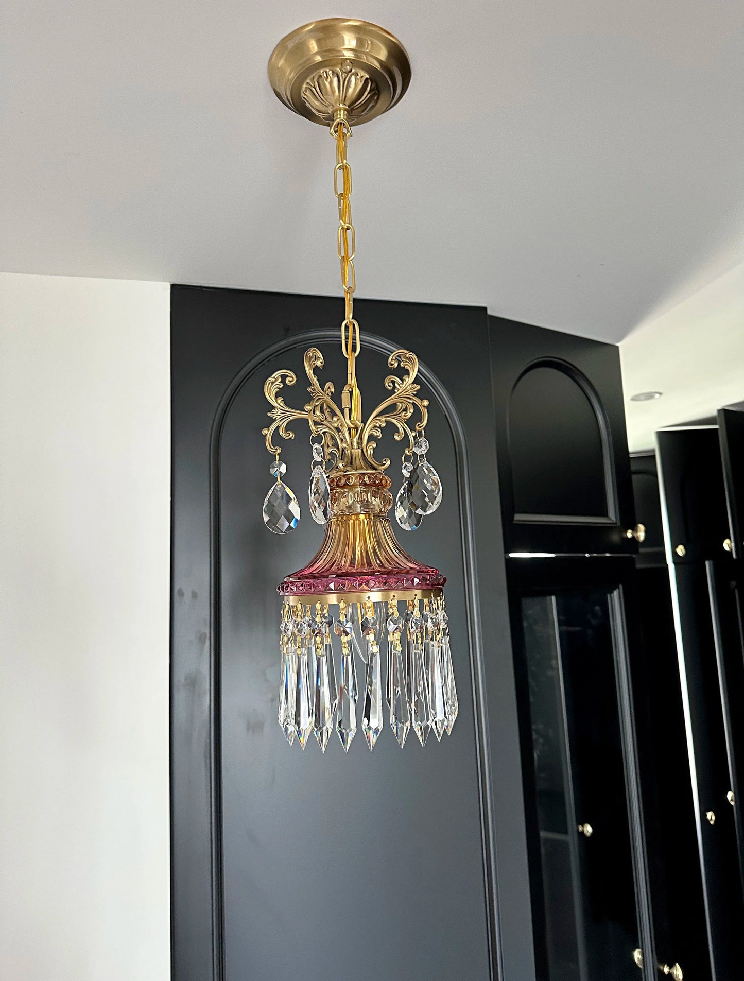 Unlit retro French crystal chandelier with gold chain and red glass, luxury pendant light for elegant home lighting.