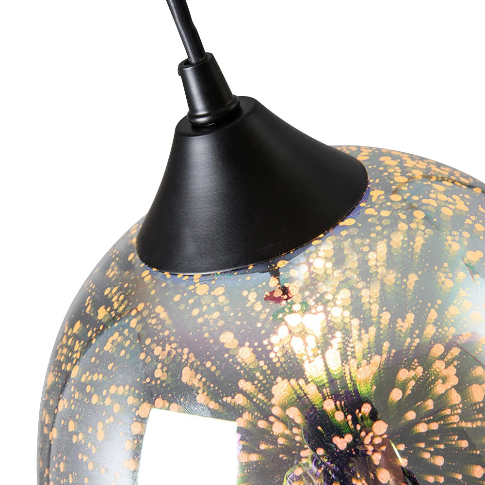 Detailed view of the top section of the glass sphere pendant light, showing the black fixture and golden speckled design.