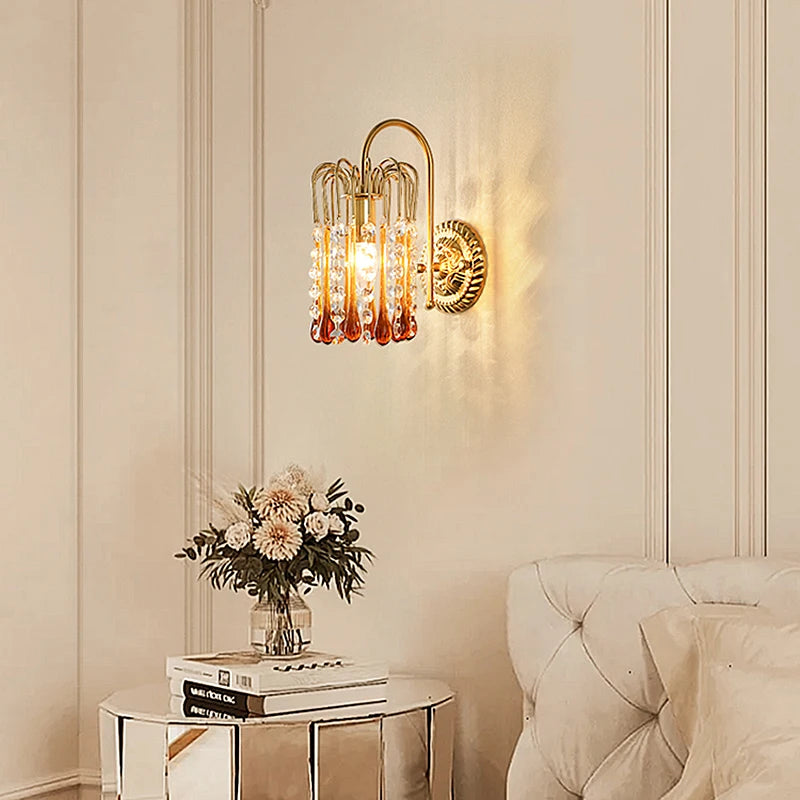 French Retro Teardrop Crystal Wall Lamp in copper, elegantly placed beside a bed, perfect for bedside or hallway ambiance lighting.
