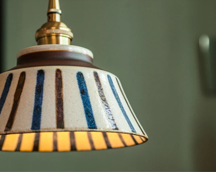 Close-up of striped ceramic shade on Retro Chinese Pendant Light. Handcrafted texture with warm LED glow.