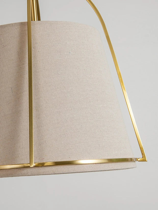 Fabric lampshade with gold trim on postmodern LED chandelier, highlighting elegant texture and modern lighting aesthetics.