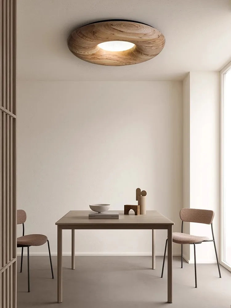 Light wood version of Nordic flush mount ceiling light installed in a minimalist dining room, enhancing natural tones and modern decor.