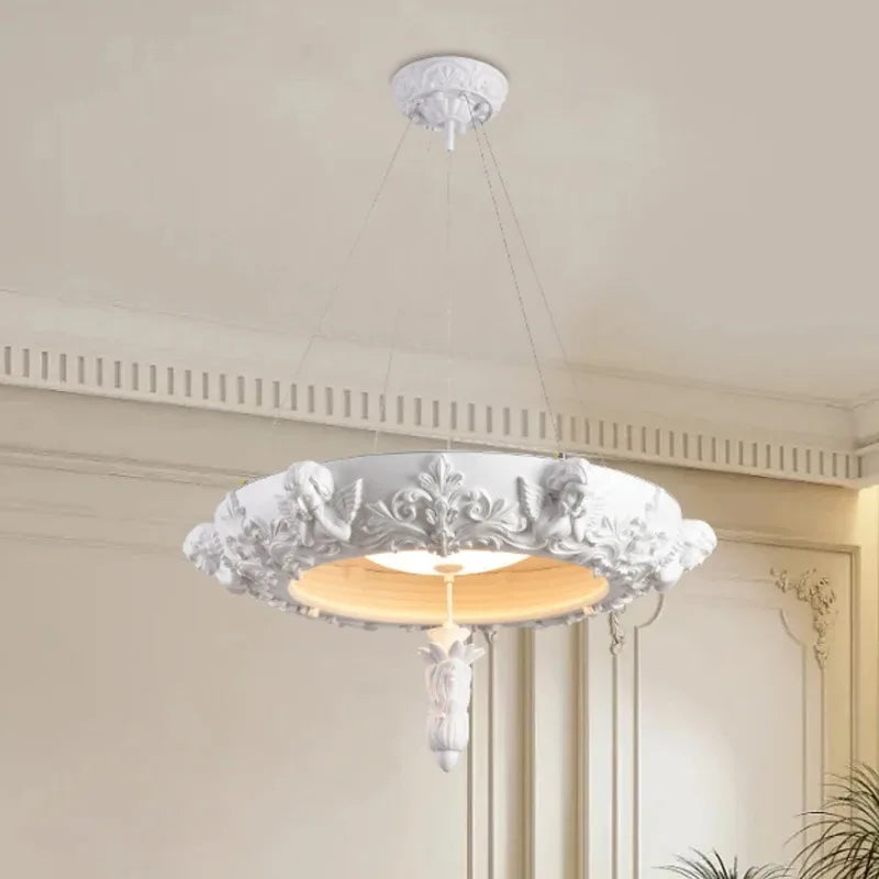 French farmhouse carved plaster chandelier with angelic and floral motifs, offering ambient LED lighting for traditional spaces.