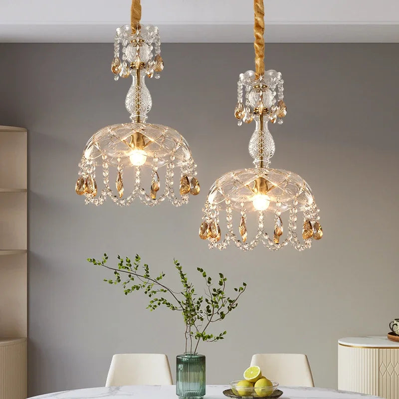 LED Crystal Chandelier Art Deco pendant lights with gold accents hanging over a dining table, ideal for elegant home lighting décor.