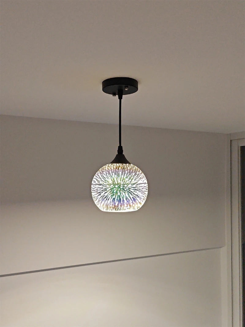 Ceiling-mounted Fireworks Glass Pendant Light with LED and E27 base, displaying a vibrant 3D burst pattern in a minimalist room.