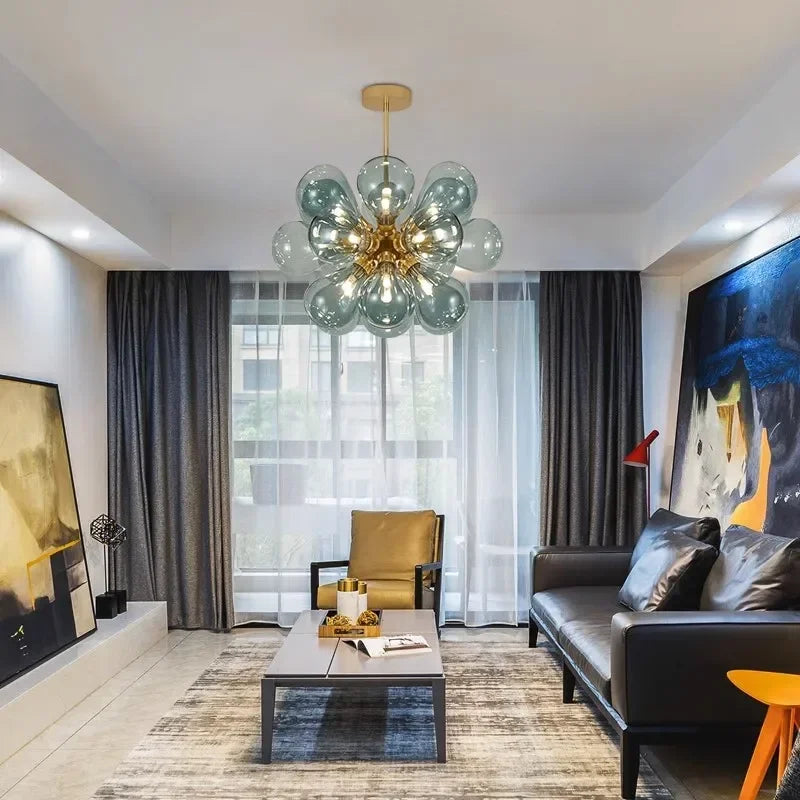 Modern Scandinavian glass chandelier in blue featured in a contemporary living room, offering stylish ambient lighting.