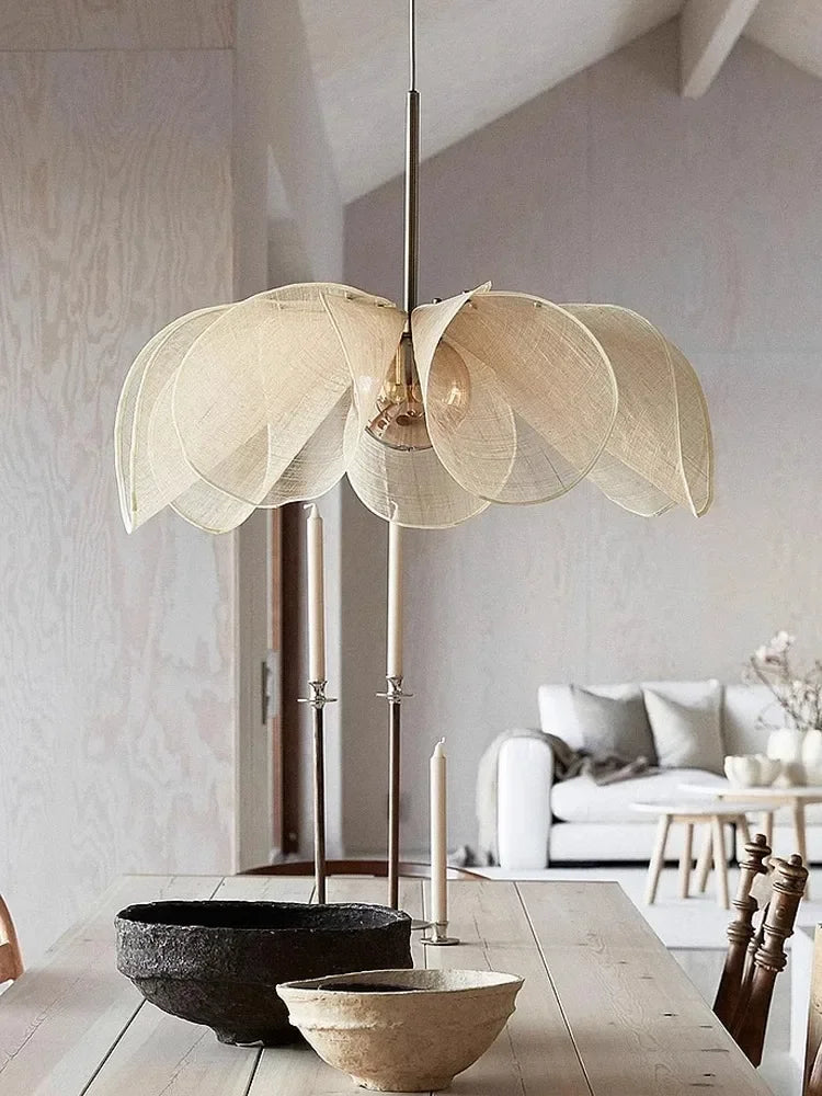 Bubble glass chandelier - modern nordic pendant light with petal-shaped fabric shade, hanging above a rustic dining table in a minimalist interior.