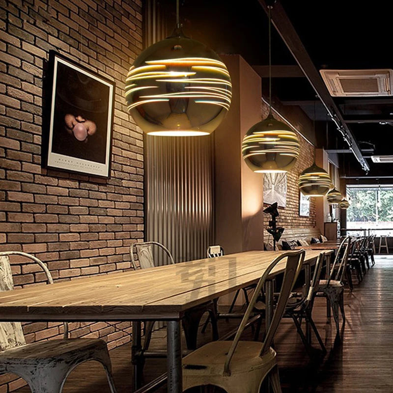 Fireworks Glass Pendant Lights with LED bulbs in a modern café setting, offering ambient lighting and stylish chrome finish.