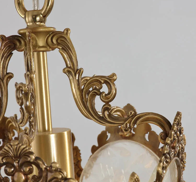 Detailed copper frame and hanging loop of French retro chandelier. Ideal for classic home lighting installations.