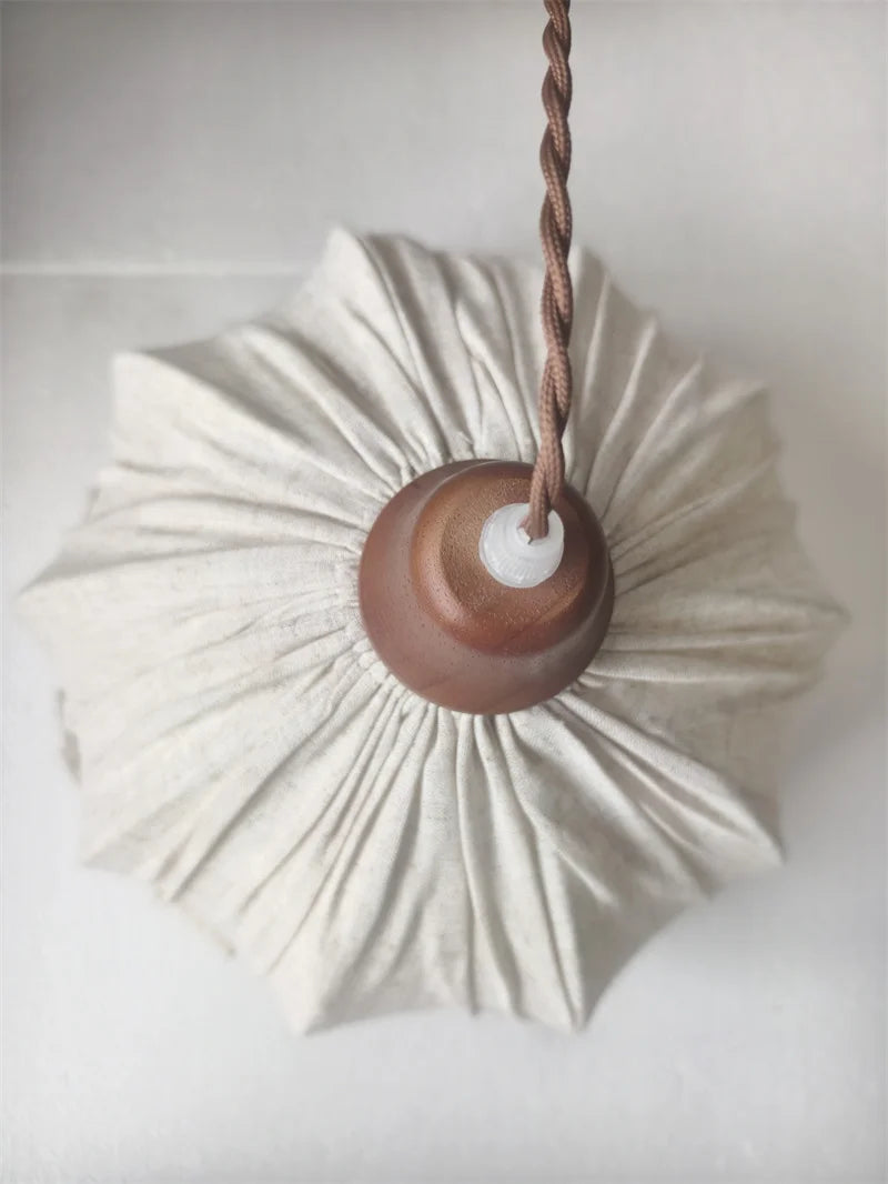Top-down view of pleated fabric pendant lamp with twisted cord, highlighting its Nordic minimalist aesthetic.