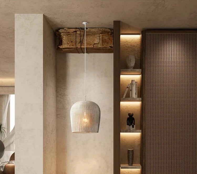 White LUXELY rattan pendant light in a warm-toned hallway, blending wabi-sabi aesthetics with functional lighting.