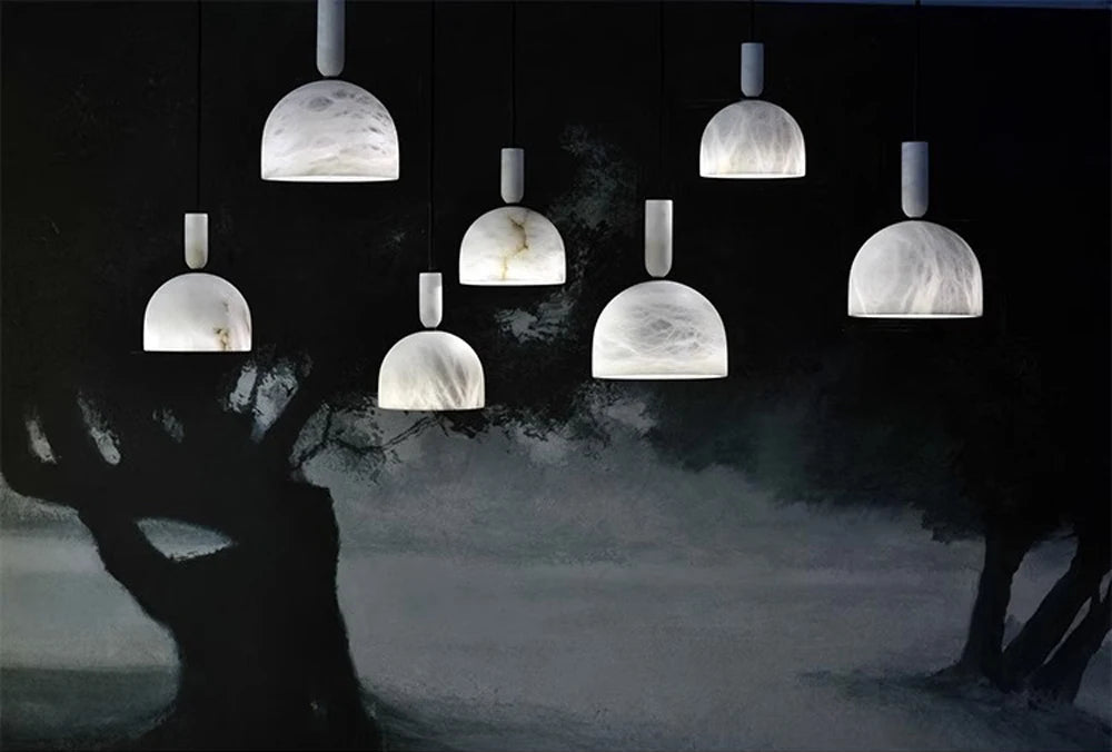 Seven dome-shaped marble LED pendant lights against a mural. Marble LED pendant light – modern ceiling lamp dimmable for artistic spaces.