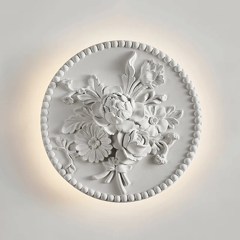 Dimmable French round vintage sconce illuminated with soft LED glow, showcasing ornate floral detailing for luxury interior wall lighting.