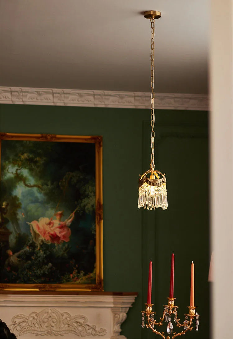 French Velvet Tassel Pendant Light suspended in a green-walled dining room, adding elegance with its crystal and copper design.