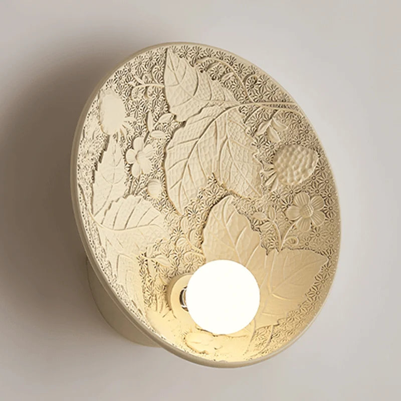 Art deco round bedside sconce with intricate botanical relief, vintage French wall lamp perfect for living room or hotel decor.