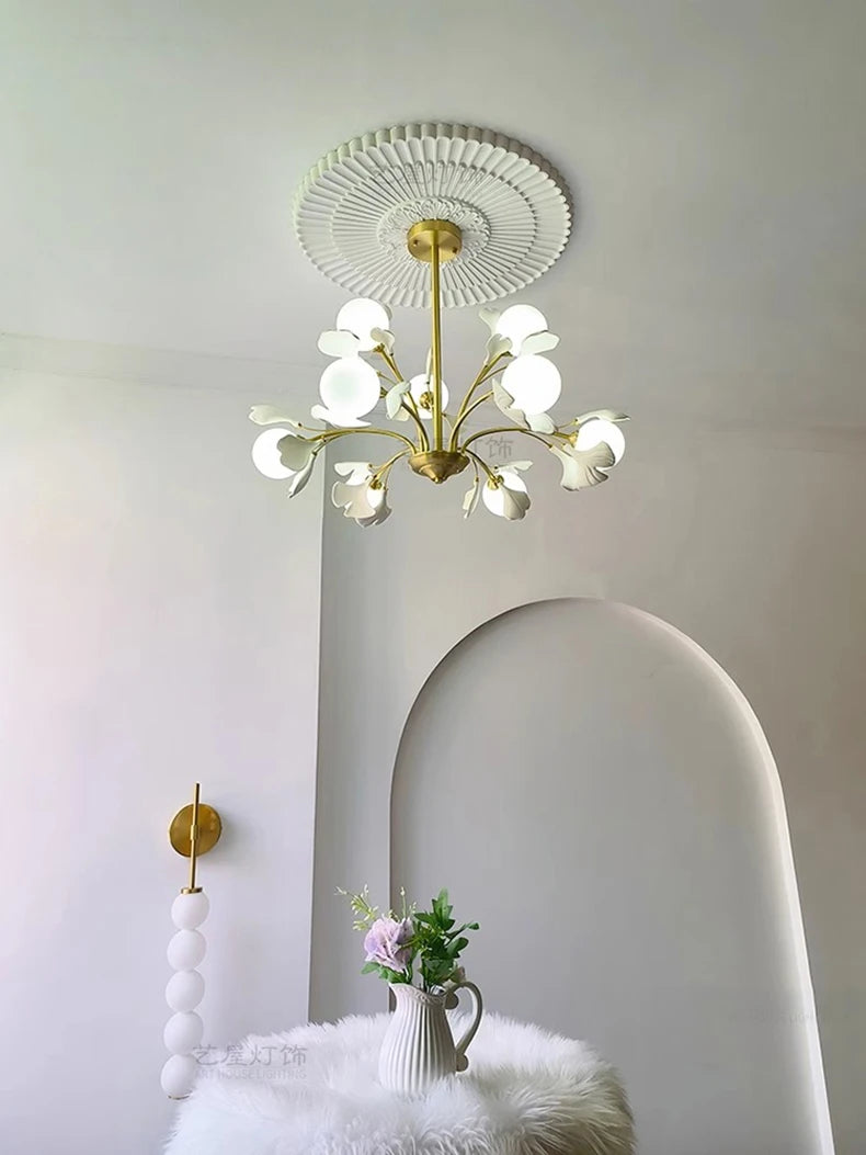 Modern dining room pendant light with floral LED bulbs, mounted on ornate ceiling medallion, adding elegance to interior decor.