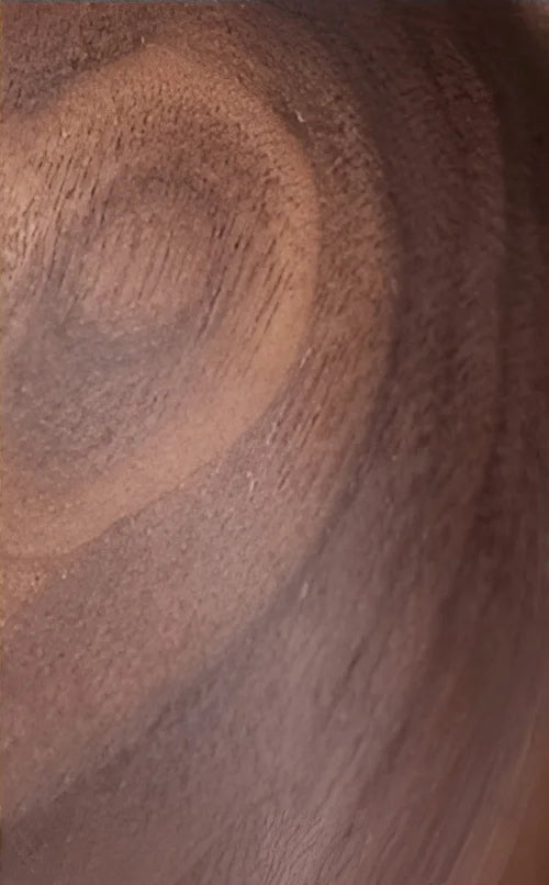 Close-up of walnut wood grain used in LUXELY wall sconce, highlighting rich natural texture and tone.