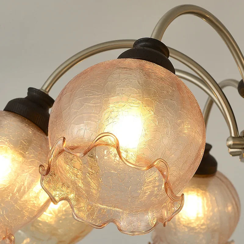 Detailed view of a ruffled crystal glass shade with LED bulb, part of the American chandelier's elegant lighting design.