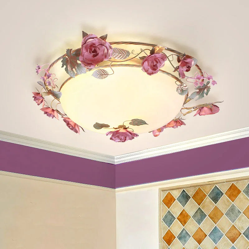 French rose romantic chandelier in a pastel-themed room. Elegant pink floral ceiling light enhances cozy bedroom ambiance.