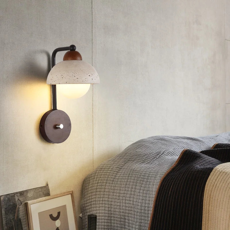 Travertine Wall Lamp mounted beside a bed, providing warm LED lighting and a natural stone finish for cozy bedroom ambiance.